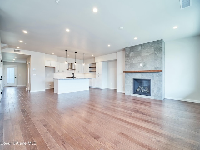 953 E Railroad Ave, Post Falls, ID 83854 - unfurnished living room featuring recessed lighting, light wood-type flooring, and a tile fireplace
