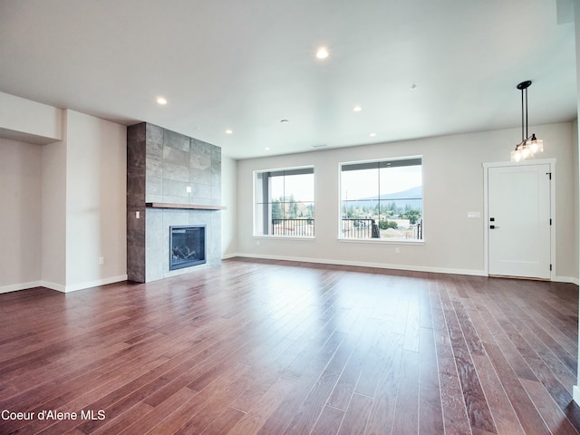 953 E Railroad Ave, Post Falls, ID 83854 - unfurnished living room featuring dark wood finished floors, a tiled fireplace, and recessed lighting