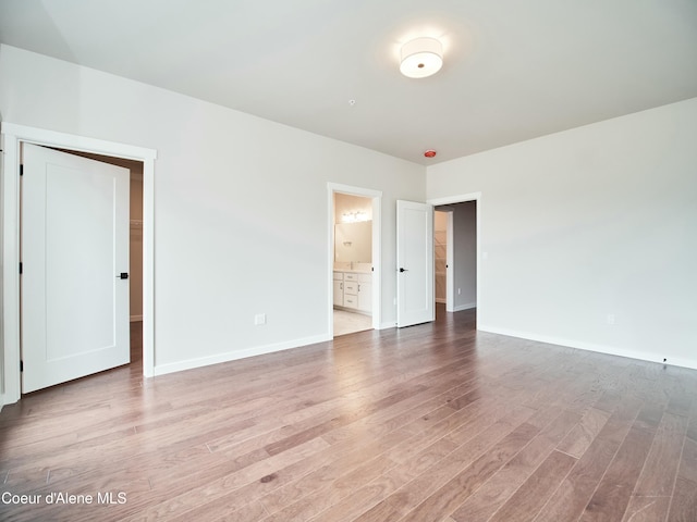953 E Railroad Ave, Post Falls, ID 83854 - empty room with light wood-style flooring and baseboards
