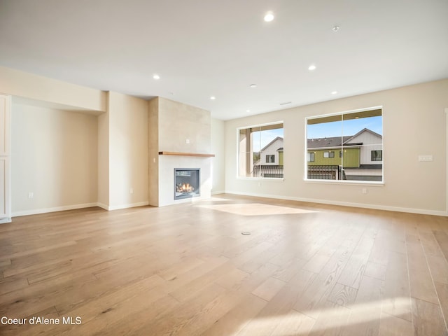 993 E Railroad Ave, Post Falls, ID 83854 - unfurnished living room with a fireplace, light wood finished floors, and recessed lighting