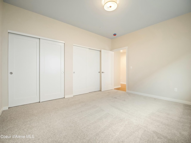 993 E Railroad Ave, Post Falls, ID 83854 - unfurnished bedroom featuring two closets and carpet floors