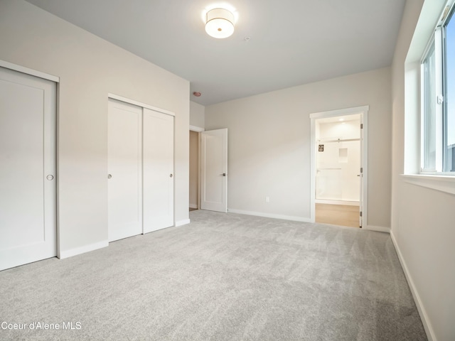 993 E Railroad Ave, Post Falls, ID 83854 - unfurnished bedroom featuring carpet flooring, two closets, and connected bathroom
