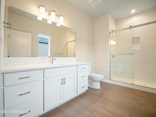 993 E Railroad Ave, Post Falls, ID 83854 - bathroom featuring a shower stall, wood finished floors, and vanity