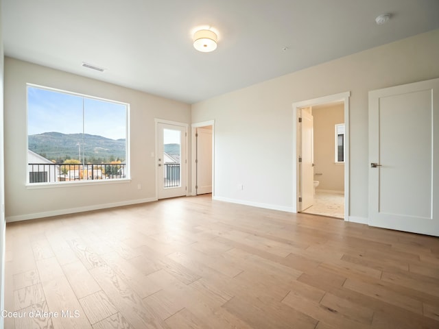 993 E Railroad Ave, Post Falls, ID 83854 - unfurnished room with light wood-style floors, a mountain view, and a smoke detector