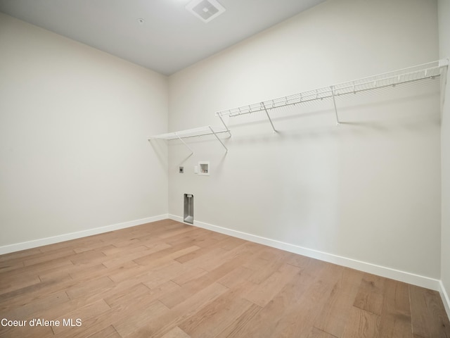 993 E Railroad Ave, Post Falls, ID 83854 - laundry room featuring electric dryer hookup, light wood finished floors, and hookup for a washing machine