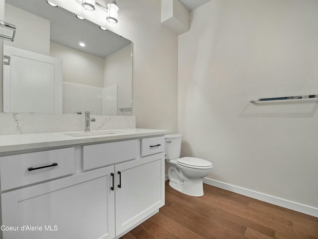 995 E Railroad Ave, Post Falls, ID 83854 - bathroom with wood finished floors, vanity, and a shower