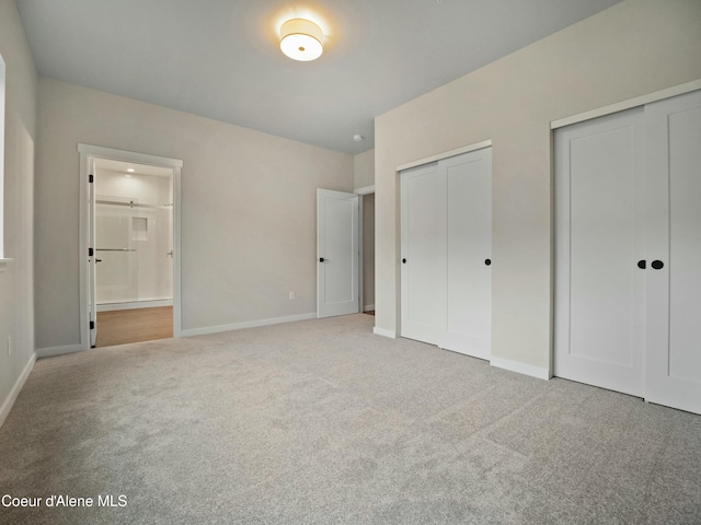 995 E Railroad Ave, Post Falls, ID 83854 - unfurnished bedroom with carpet floors, two closets, and ensuite bath