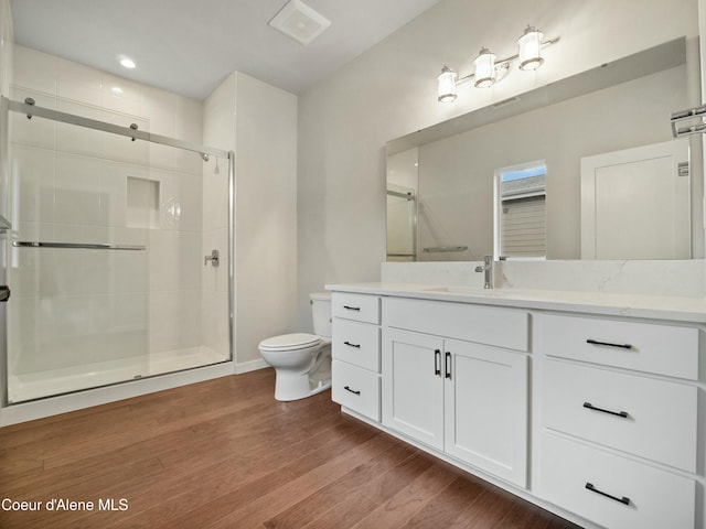 995 E Railroad Ave, Post Falls, ID 83854 - bathroom featuring vanity, a stall shower, and wood finished floors