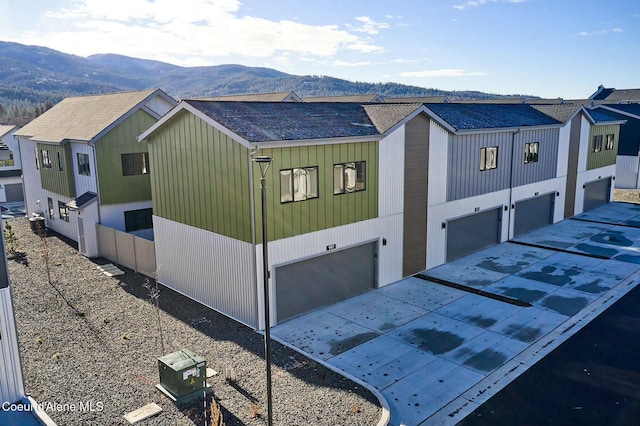 995 E Railroad Ave, Post Falls, ID 83854 - view of side of property with a mountain view, roof with shingles, an attached garage, and driveway