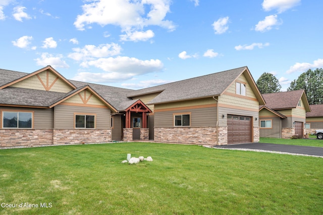24 Bellflower, Blanchard, ID 83804 - craftsman house featuring roof with shingles, a front yard, driveway, and stone siding