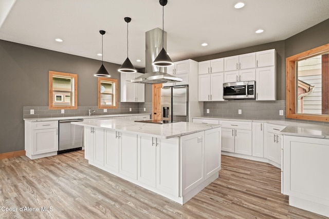 24 Bellflower, Blanchard, ID 83804 - kitchen with appliances with stainless steel finishes, island range hood, a center island, light wood finished floors, and recessed lighting