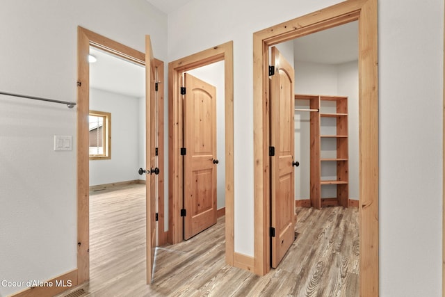 24 Bellflower, Blanchard, ID 83804 - hallway featuring wood finished floors and baseboards