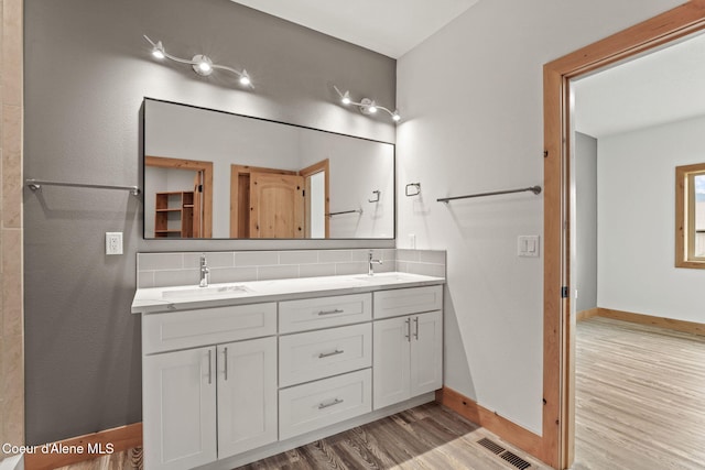 24 Bellflower, Blanchard, ID 83804 - bathroom with wood finished floors, double vanity, and backsplash