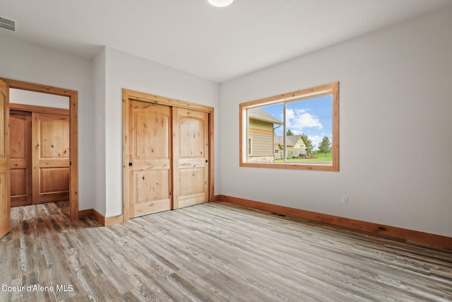 24 Bellflower, Blanchard, ID 83804 - unfurnished bedroom featuring wood finished floors and a closet