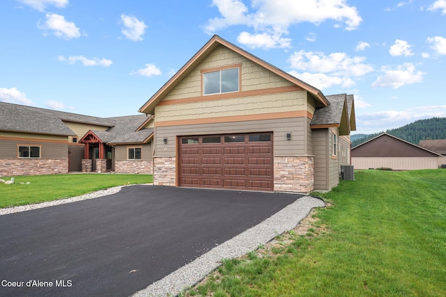 24 Bellflower, Blanchard, ID 83804 - craftsman-style house featuring asphalt driveway, stone siding, a front yard, an attached garage, and roof with shingles
