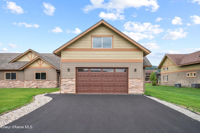 24 Bellflower, Blanchard, ID 83804 - craftsman-style house featuring stone siding, driveway, a front lawn, and a garage