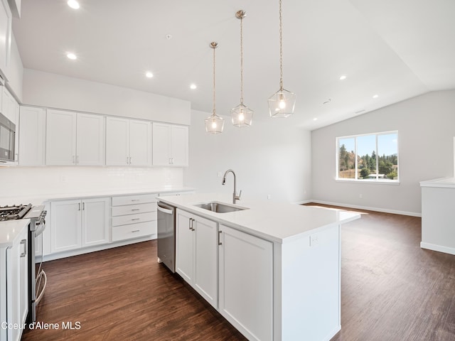 962 E Railroad Ave, Post Falls, ID 83854 - kitchen with appliances with stainless steel finishes, lofted ceiling, dark wood-style flooring, light countertops, and white cabinets