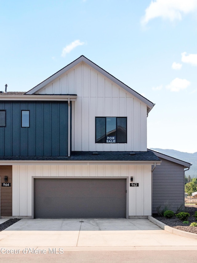 962 E Railroad Ave, Post Falls, ID 83854 - view of side of home with a garage, driveway, and board and batten siding