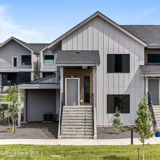 962 E Railroad Ave, Post Falls, ID 83854 - modern farmhouse with board and batten siding, a shingled roof, and a balcony