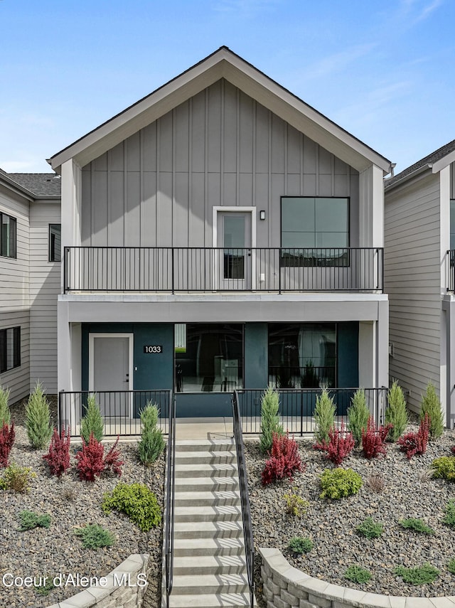 1033 E Railroad Ave, Post Falls, ID 83854 - view of front of house with board and batten siding, stairs, and a balcony
