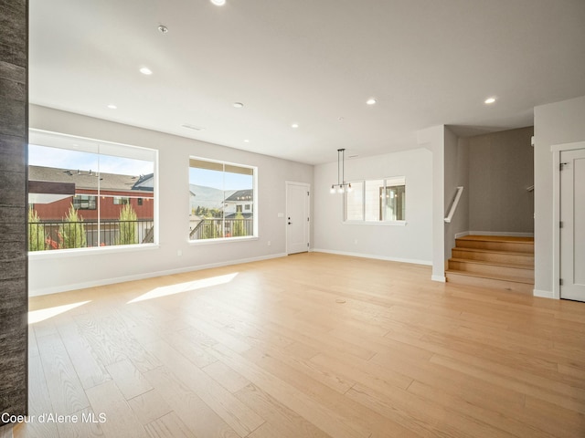 1033 E Railroad Ave, Post Falls, ID 83854 - unfurnished living room featuring light wood finished floors, stairs, recessed lighting, and a chandelier