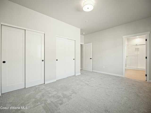 1033 E Railroad Ave, Post Falls, ID 83854 - unfurnished bedroom with two closets, carpet flooring, and connected bathroom