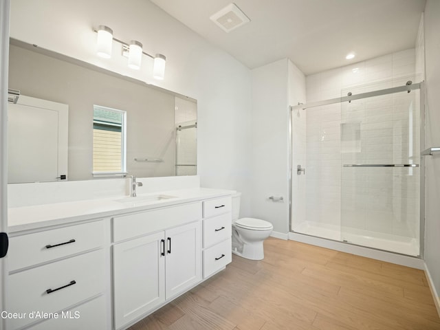 1033 E Railroad Ave, Post Falls, ID 83854 - full bath featuring a stall shower, vanity, wood finished floors, and recessed lighting