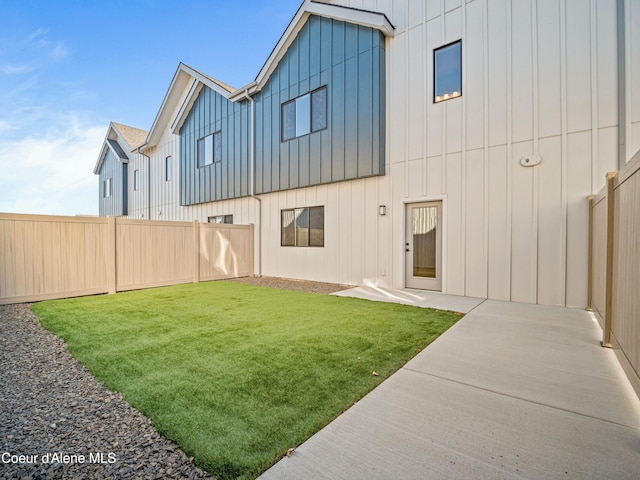 1033 E Railroad Ave, Post Falls, ID 83854 - rear view of property featuring board and batten siding and a patio
