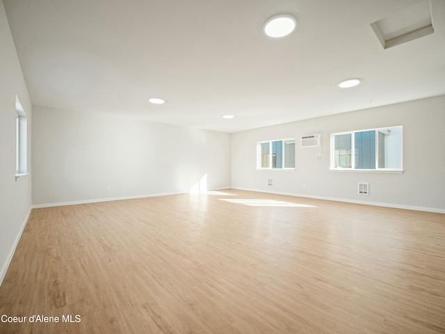 1033 E Railroad Ave, Post Falls, ID 83854 - spare room with light wood-type flooring, a wall unit AC, attic access, and recessed lighting