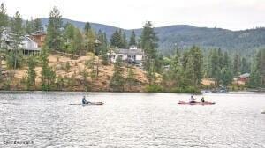 1033 E Railroad Ave, Post Falls, ID 83854 - water view featuring a mountain backdrop and a forest