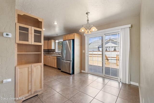 59 W Lincoln Ave, Priest River, ID 83856 - kitchen featuring appliances with stainless steel finishes, light brown cabinetry, a textured wall, open shelves, and a chandelier