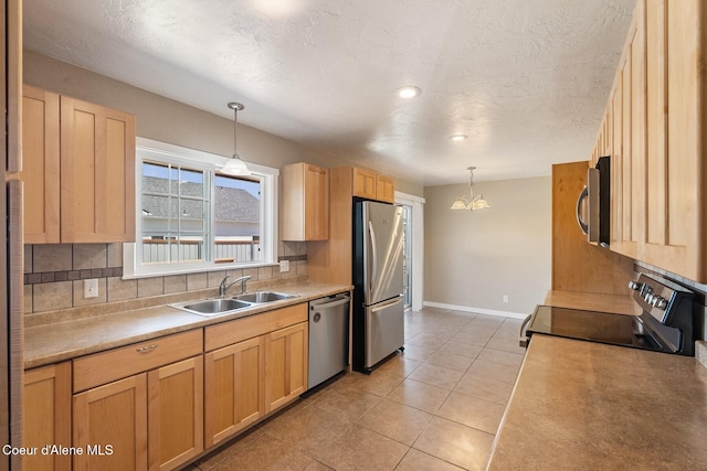 59 W Lincoln Ave, Priest River, ID 83856 - kitchen featuring appliances with stainless steel finishes, decorative backsplash, a textured ceiling, and pendant lighting