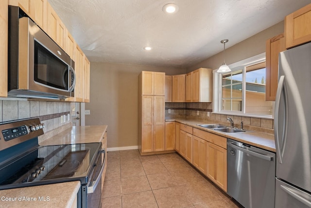 59 W Lincoln Ave, Priest River, ID 83856 - kitchen with stainless steel appliances, light brown cabinets, decorative backsplash, light countertops, and recessed lighting