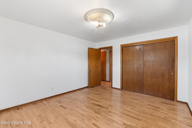 59 W Lincoln Ave, Priest River, ID 83856 - unfurnished bedroom with light wood finished floors and a closet