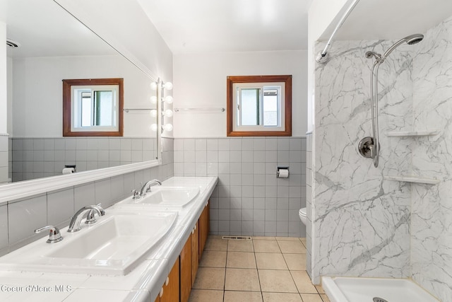59 W Lincoln Ave, Priest River, ID 83856 - full bath featuring tile walls, a marble finish shower, double vanity, tile patterned floors, and a wainscoted wall