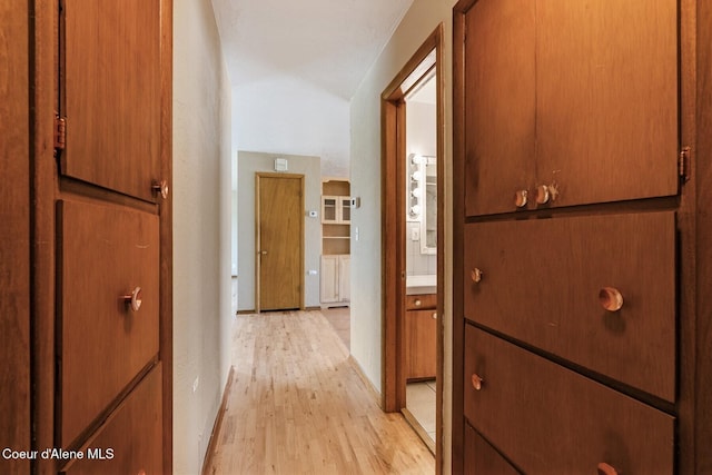 59 W Lincoln Ave, Priest River, ID 83856 - hallway featuring light wood-type flooring and vaulted ceiling