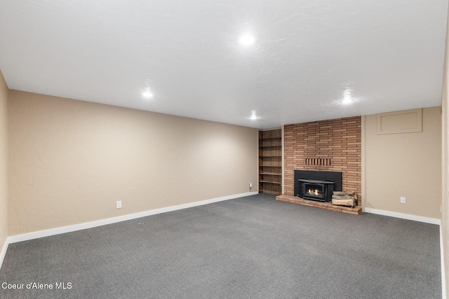 59 W Lincoln Ave, Priest River, ID 83856 - unfurnished living room with carpet floors, a fireplace, built in shelves, and recessed lighting