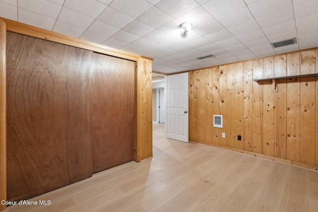 59 W Lincoln Ave, Priest River, ID 83856 - empty room with wood finished floors, wood walls, and heating unit