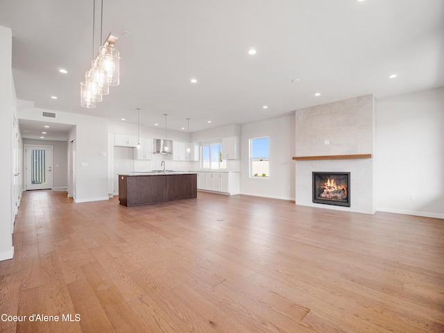 1037 E Railroad Ave, Post Falls, ID 83854 - unfurnished living room with light wood-type flooring, recessed lighting, and a fireplace