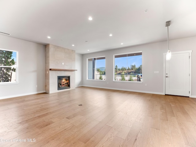 1037 E Railroad Ave, Post Falls, ID 83854 - unfurnished living room with light wood-style floors, recessed lighting, and a fireplace