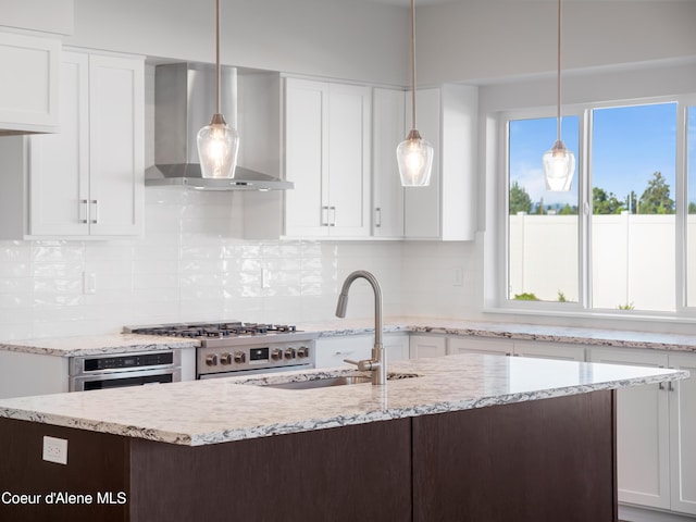 1037 E Railroad Ave, Post Falls, ID 83854 - kitchen featuring wall chimney exhaust hood, appliances with stainless steel finishes, and white cabinetry