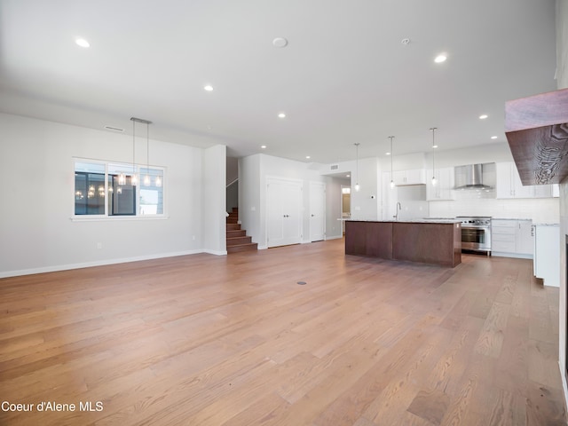 1037 E Railroad Ave, Post Falls, ID 83854 - unfurnished living room with light wood finished floors, stairway, and recessed lighting