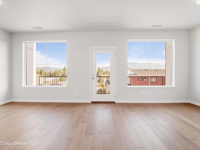 1037 E Railroad Ave, Post Falls, ID 83854 - unfurnished living room featuring wood finished floors and plenty of natural light