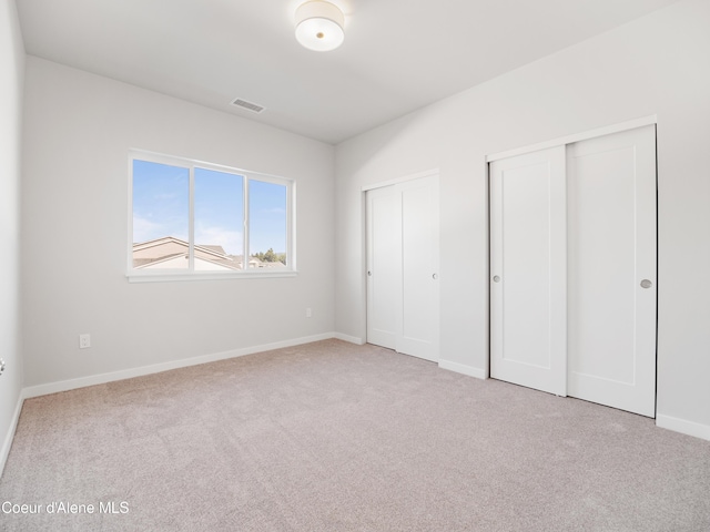1037 E Railroad Ave, Post Falls, ID 83854 - unfurnished bedroom featuring multiple closets and carpet