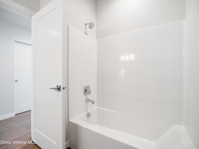 1037 E Railroad Ave, Post Falls, ID 83854 - bathroom featuring washtub / shower combination and wood finished floors