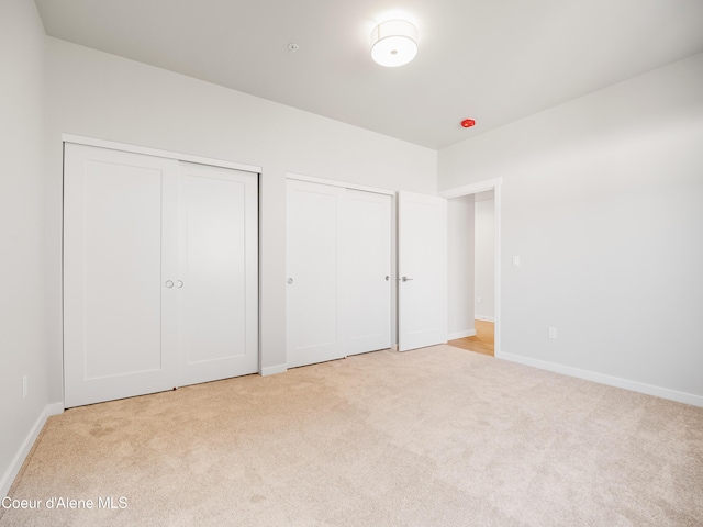 1037 E Railroad Ave, Post Falls, ID 83854 - unfurnished bedroom featuring two closets and light carpet