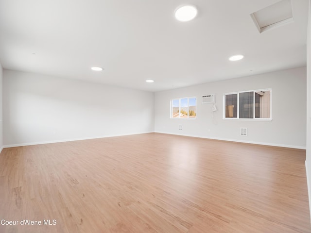 1037 E Railroad Ave, Post Falls, ID 83854 - spare room with light wood-style floors, a wall mounted AC, recessed lighting, and attic access
