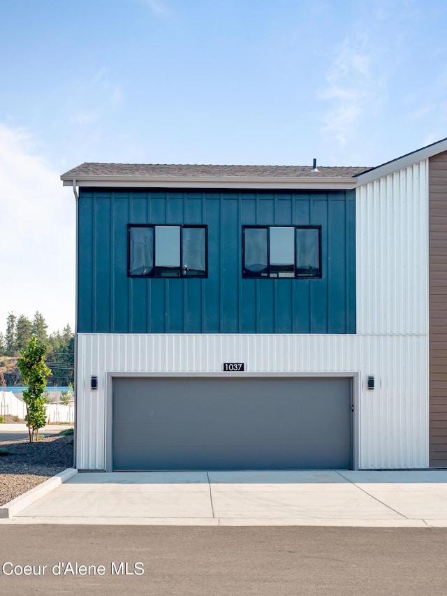 1037 E Railroad Ave, Post Falls, ID 83854 - contemporary house featuring board and batten siding, a garage, driveway, and roof with shingles
