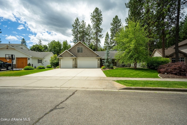 5188 E Twila Ct, Post Falls, ID 83854 - view of front of home featuring driveway, a garage, a front yard, and stone siding