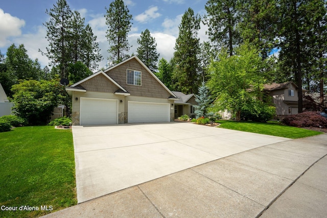 5188 E Twila Ct, Post Falls, ID 83854 - craftsman-style house with driveway, stone siding, and a garage